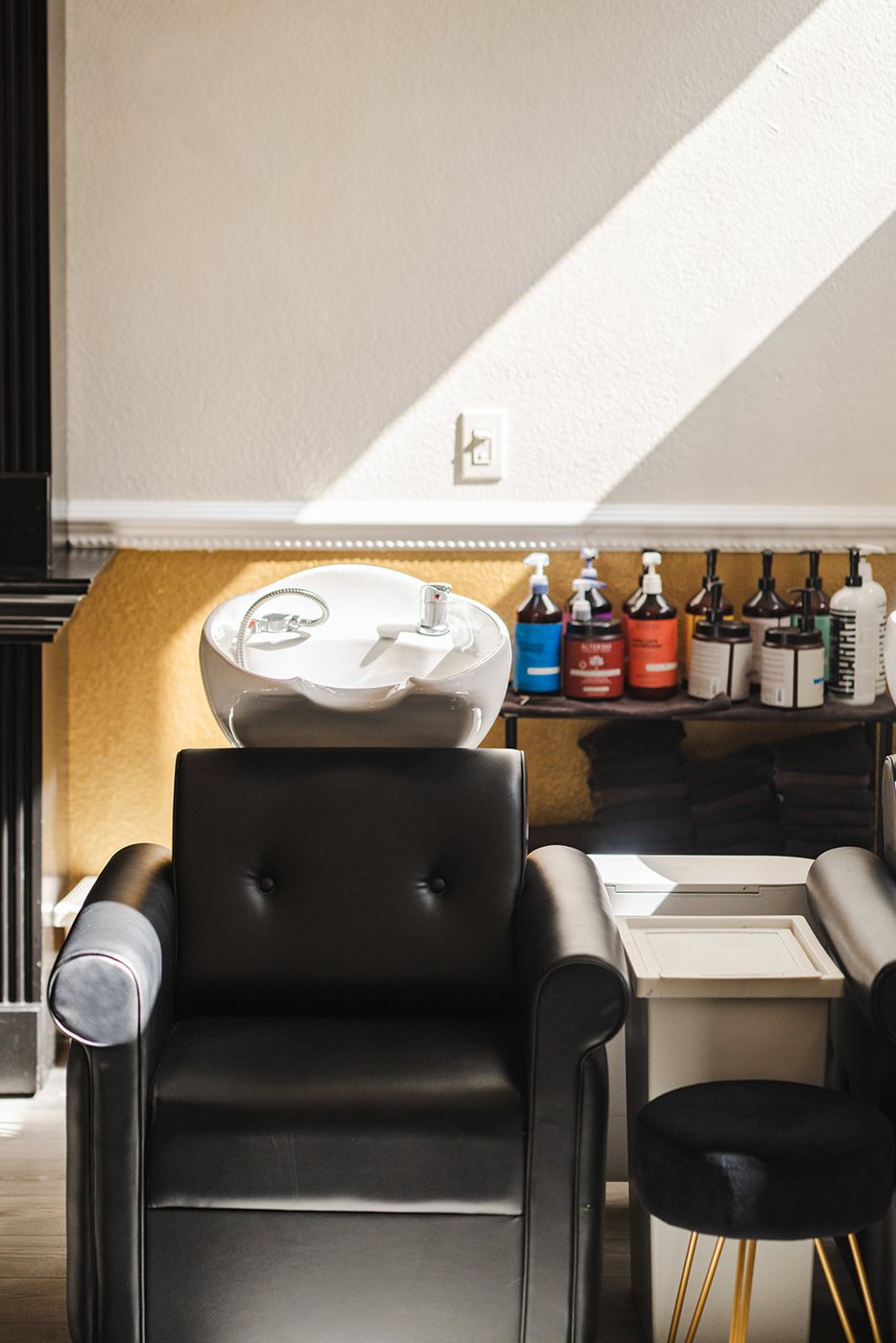 Stylist placing beaded row hair extensions in Denver